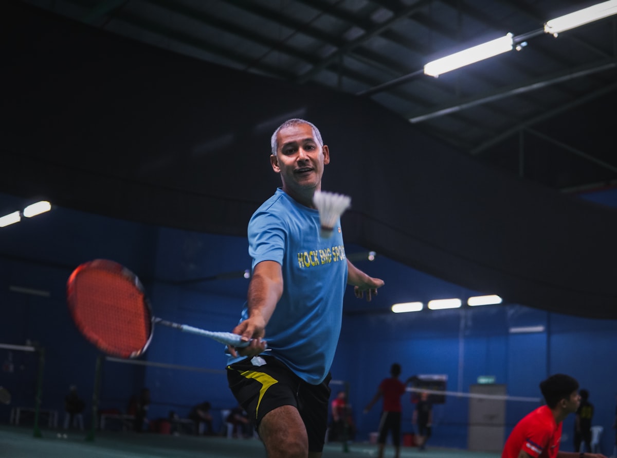 Young athlete in competitive badminton match